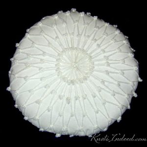 12 inch circular fiber-filled pillow covered with netting on both sides