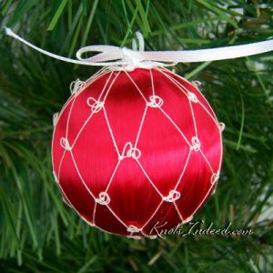 satin ornament ball enclosed in decorative netting