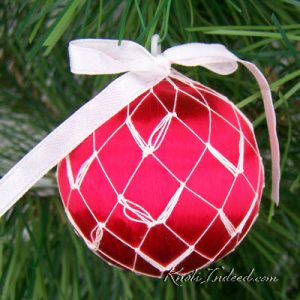satin ornament ball enclosed in decorative netting