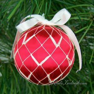 satin ornament ball enclosed in decorative netting